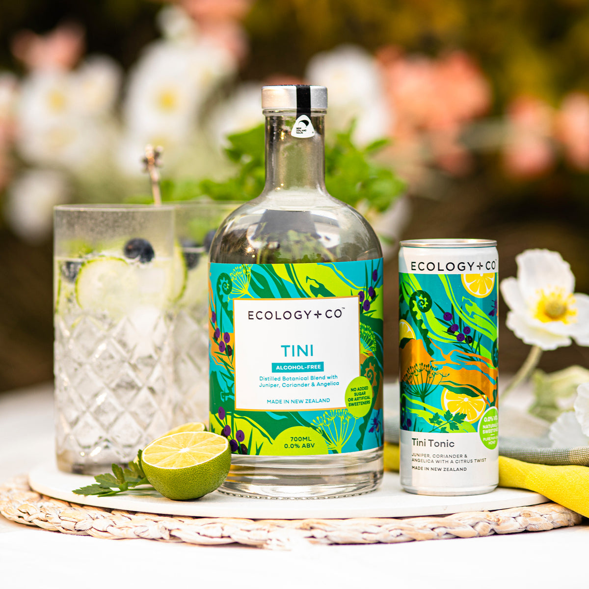 Ecology & Co Tini Botanical Blend bottle and ready-to-drink Tini Tonic can on garden table