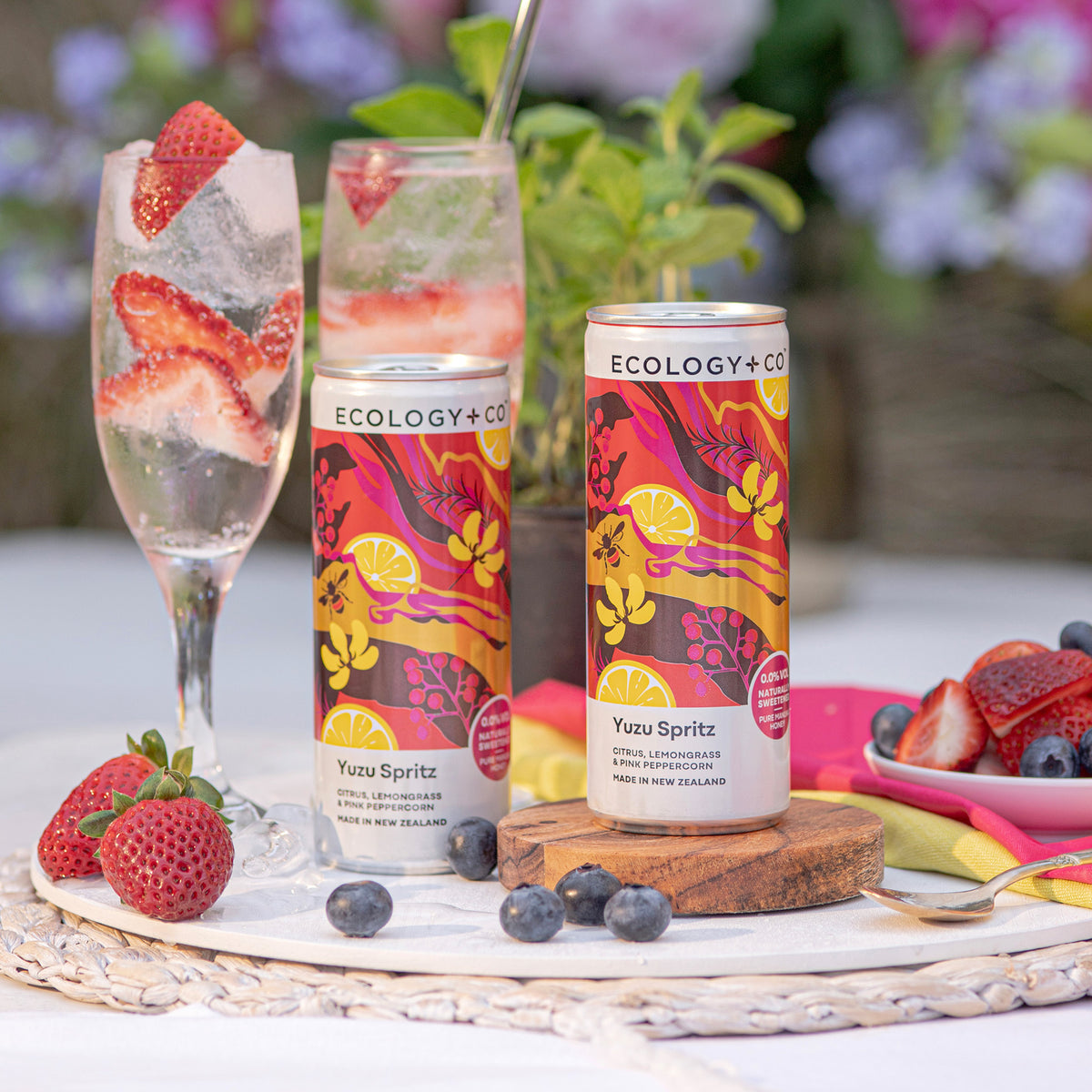 Ecology & Co Yuzu Spritz ready-to-drink cans on garden table